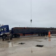 A load of 20+ metre beams are lifted off the Southdown lorry, complete with trombone trailer A load of 20+ metre beams are lifted off the Southdown lorry, complete with trombone trailer