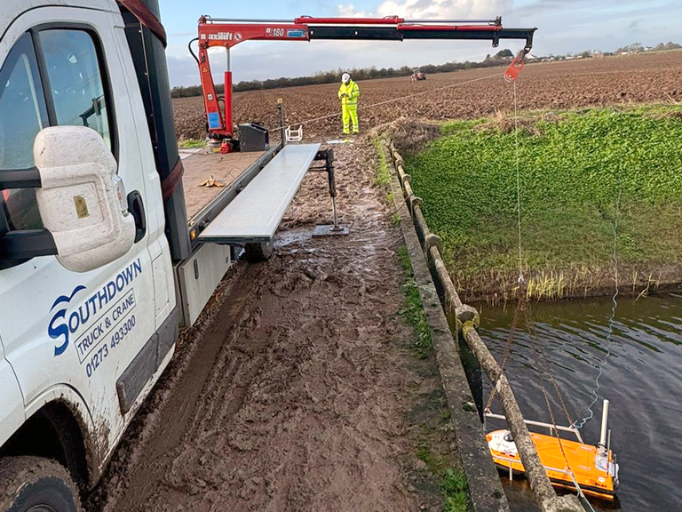 The Southdown team using a lightweight crane to deploy an ROV platform to map some watercourses on the Fens